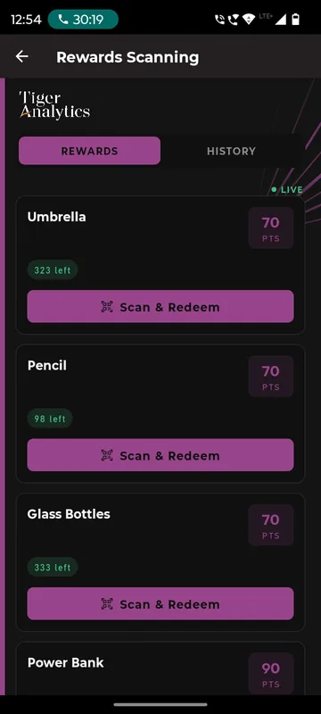Rewards scanning page with live reward items such as umbrella, pencil and glass bottles showing points cost, stock left and a Scan and Redeem button
