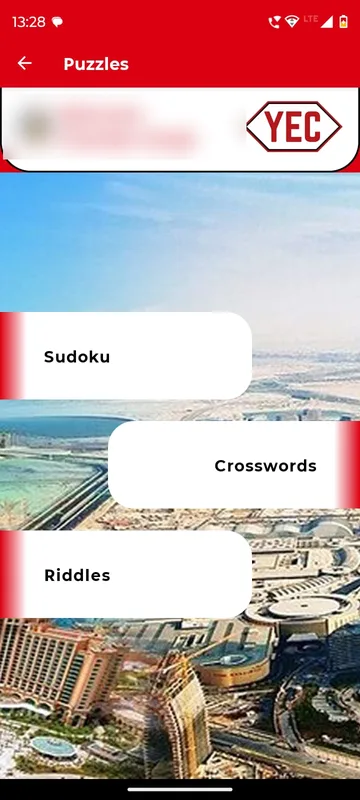 Puzzles page with three game cards for Sudoku, Crosswords and Riddles over a Dubai skyline background